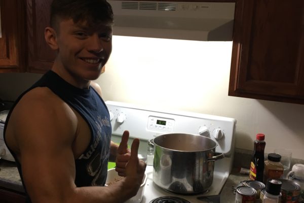 Brother Austin Nault cooking up some signature spicy chili for the Acacia Lock-In