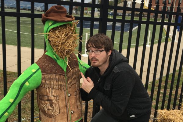 Brother Travis Riddle taking a selfie with our newly stuffed cactus cowboy scarecrow for Fall Fest.